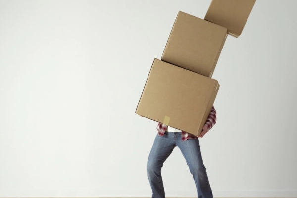 Man holding three cardboard boxes