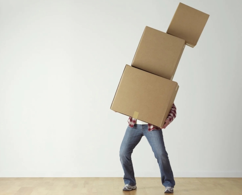 Man holding three cardboard boxes